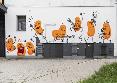 Streetart Werk an einer Wand. Zusehen sind 8 taneznde und musikspielende orangefarbene Bohnen.
